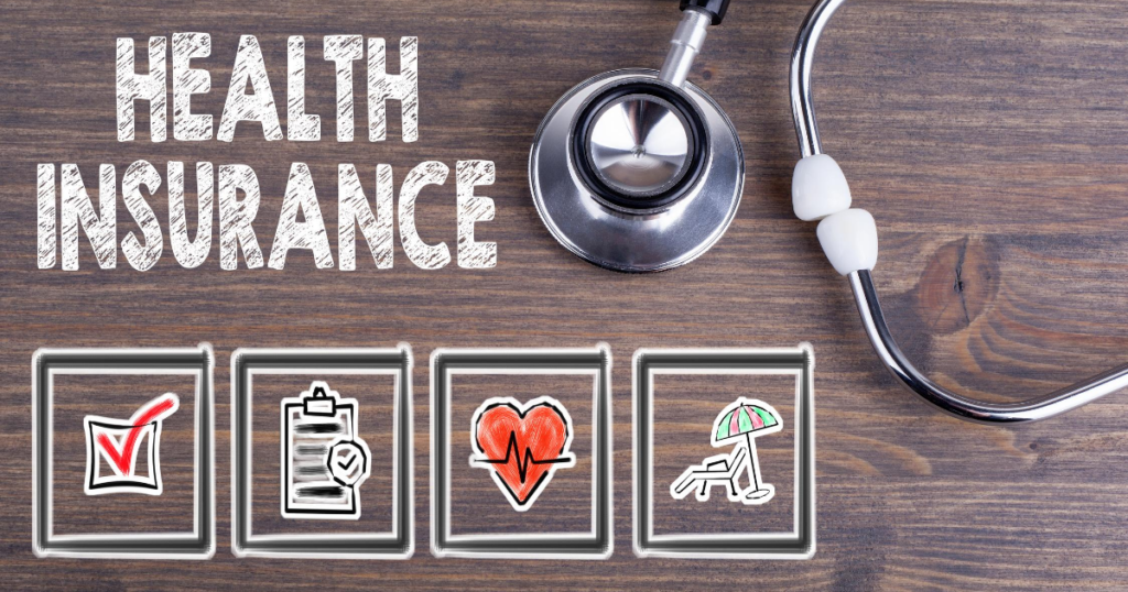 health insurance written in chalk on table top with stethoscope