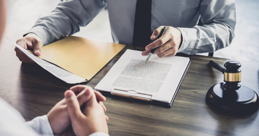 lawyer reviewing case file with client